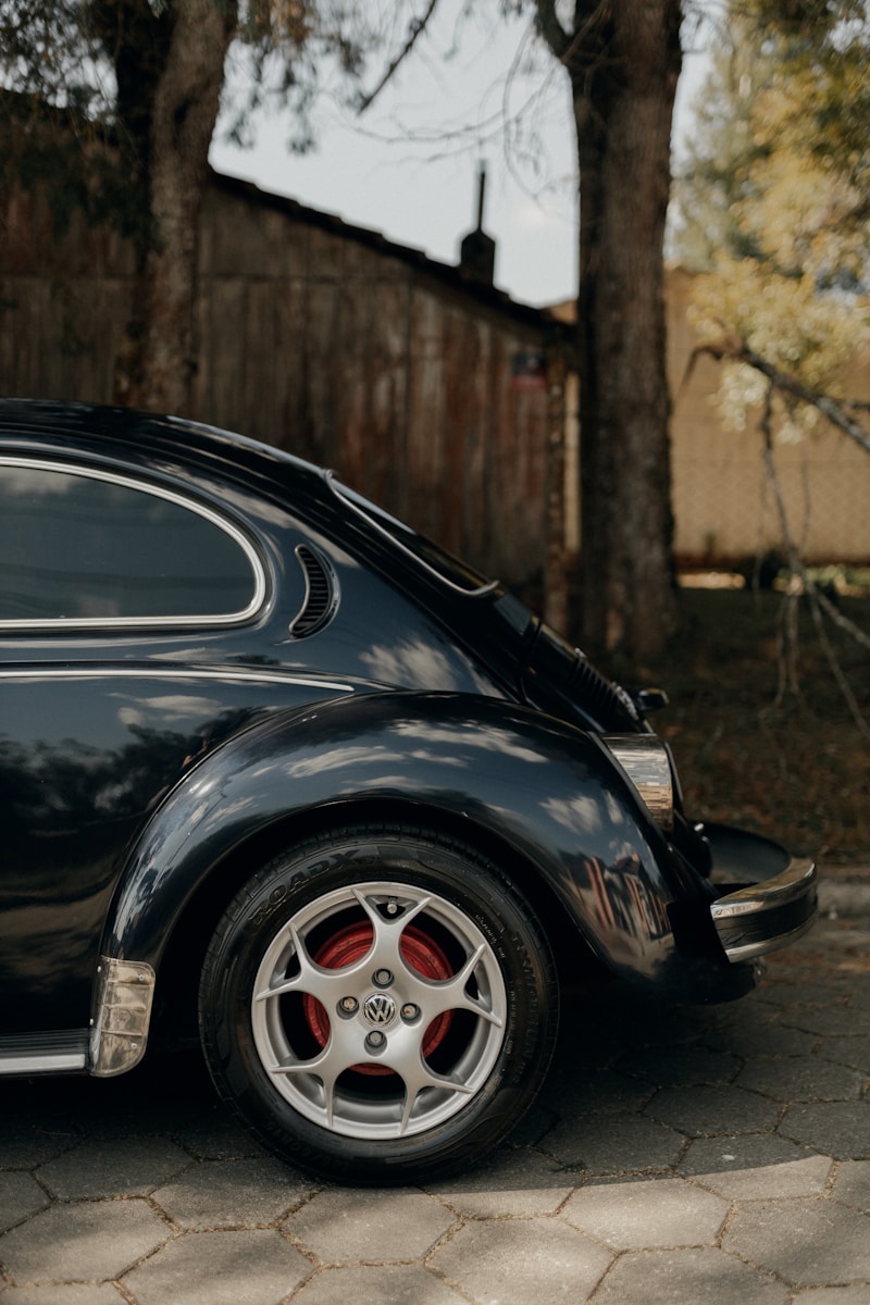 Vintage black volkswagen beetle parked outdoors.